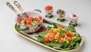 Tofu Scramble served on a bed of fresh spinach leaves, alongside vegan cream cheese, olives, roasted peppers, and a side salad. Photography: Revital Topiol.